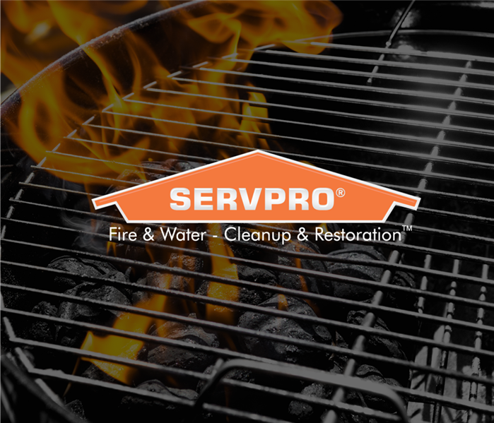 Grill with coals on fire with the Servpro logo over top